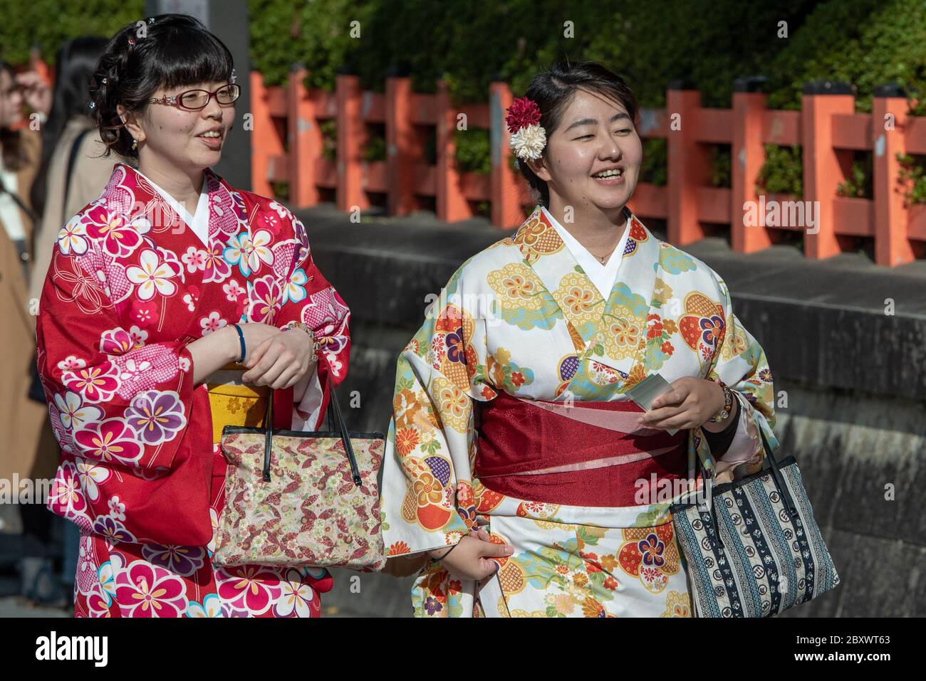 Young apprentice geishas called Maiko walking the main street in Gion district in Kyoto Japan Stock Photo