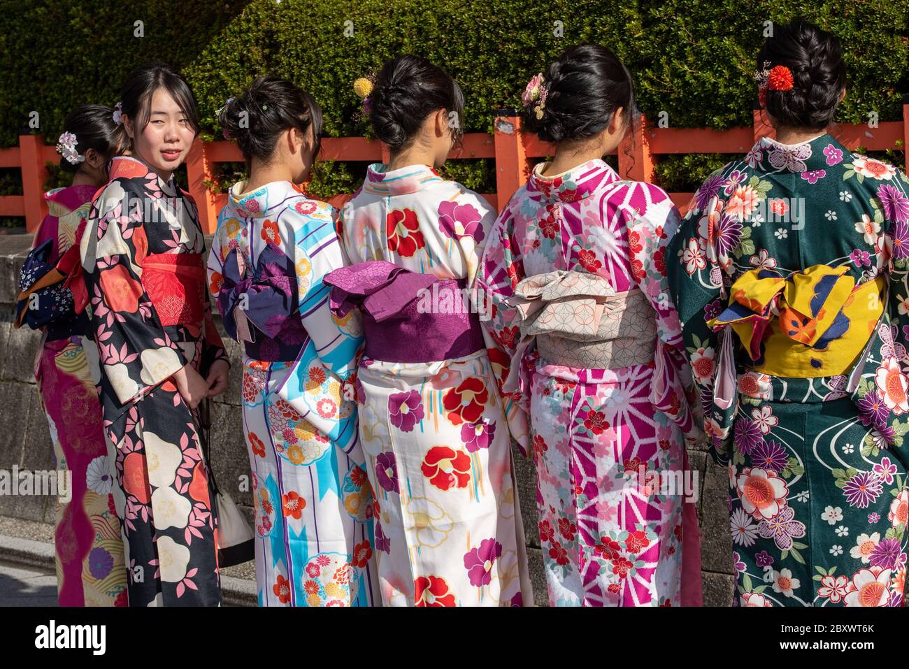 Young apprentice geishas called Maiko walking the main street in Gion district in Kyoto Japan Stock Photo