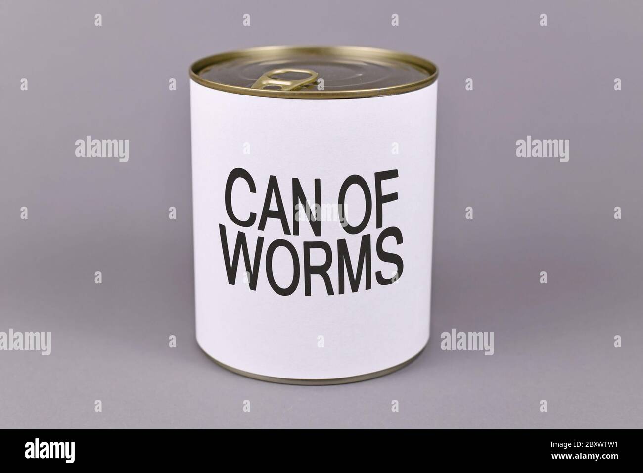 Concept for dfifficult situations and unpleasant experiences showing a tin can with white label and words 'Can of worms' on gray background Stock Photo