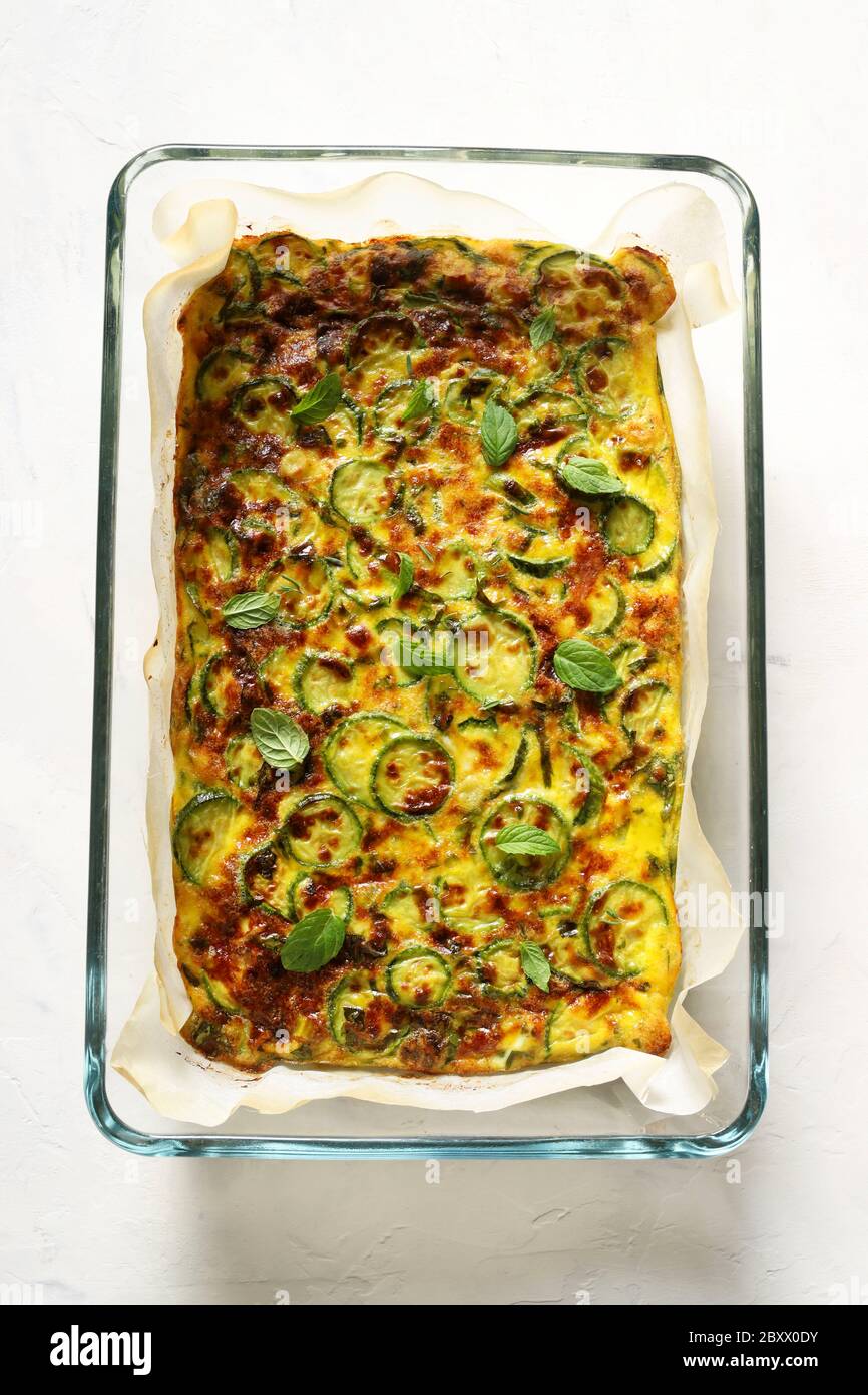 Food concept. Oven baked omelette with zucchini, leeks and cheese in a