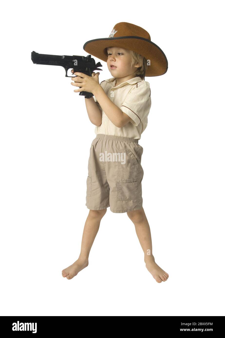 Boy with a toy gun in a hat over white background Stock Photo