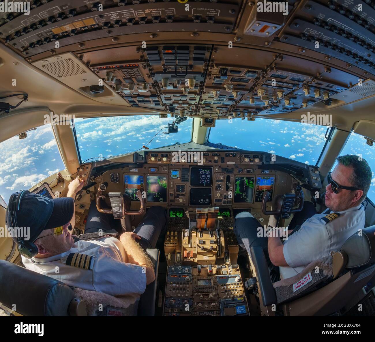 Cockpit view in Boeing 757-200 with pilot and co-pilot Stock Photo