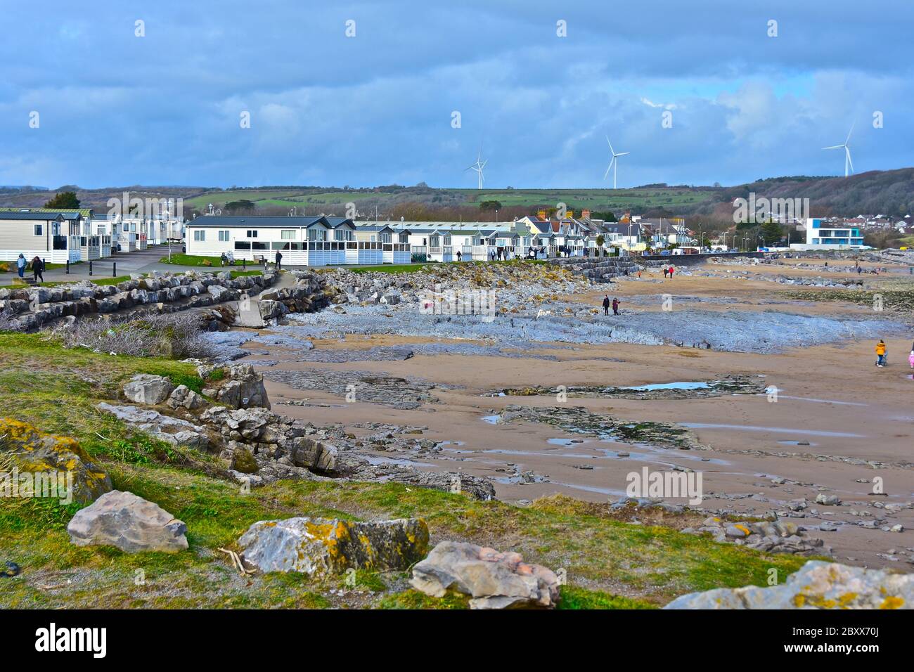 A view across the bay at Newton beach near Porthcawl showing the unspoilt coastline at low tide