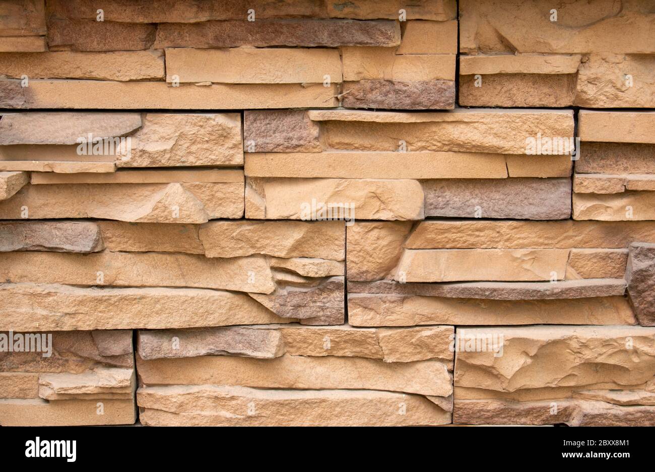 Stone facing of facades and walls.The wall is made of decorative facing stone, such as Sandstone