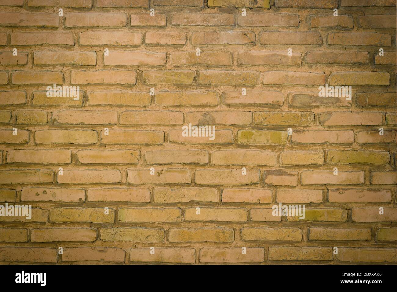 A section of a send brown brick wall background Stock Photo