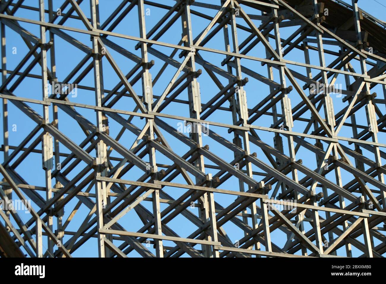 Wooden roller coaster support beams against blue sky Stock Photo - Alamy
