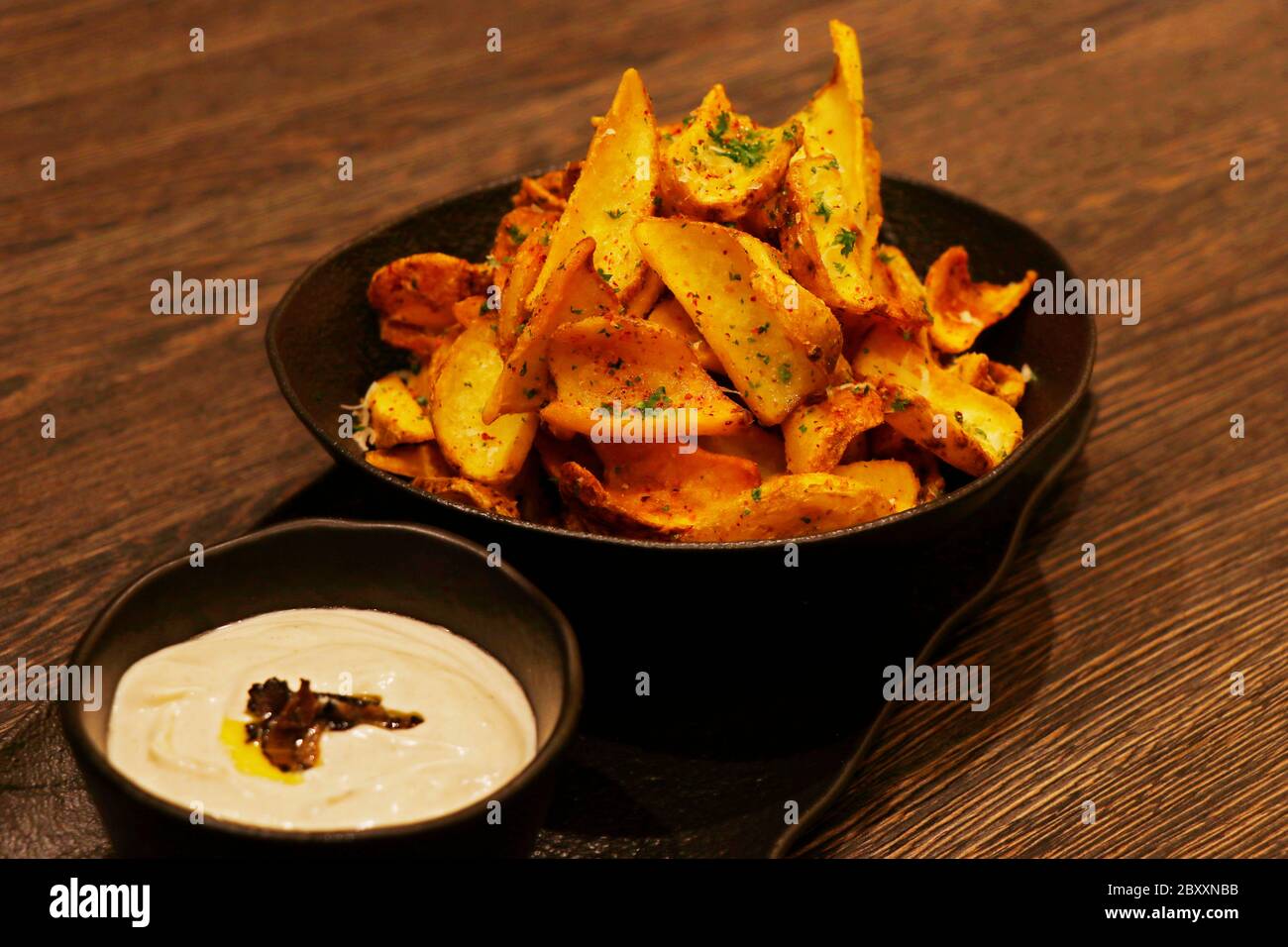 crispy fried potato chips or wedges with truffle cream dip Stock Photo