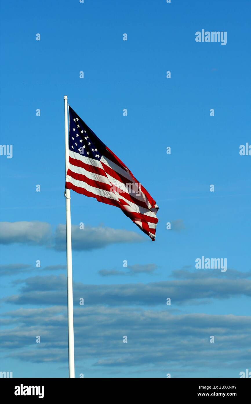 A American flag waving with blue sky Stock Photo