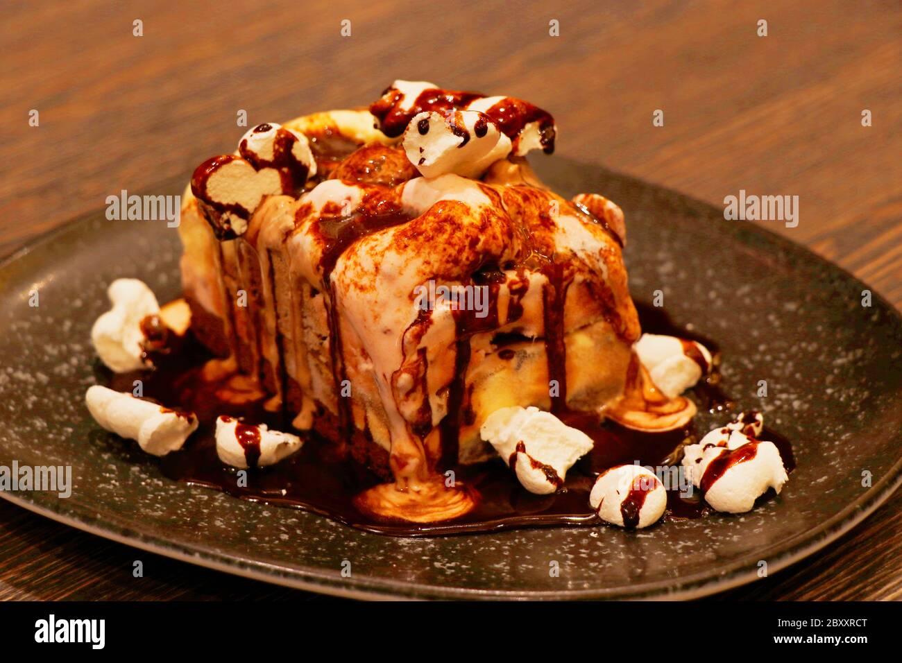 melted chocolate cake with vanilla and raspberry filling Stock Photo
