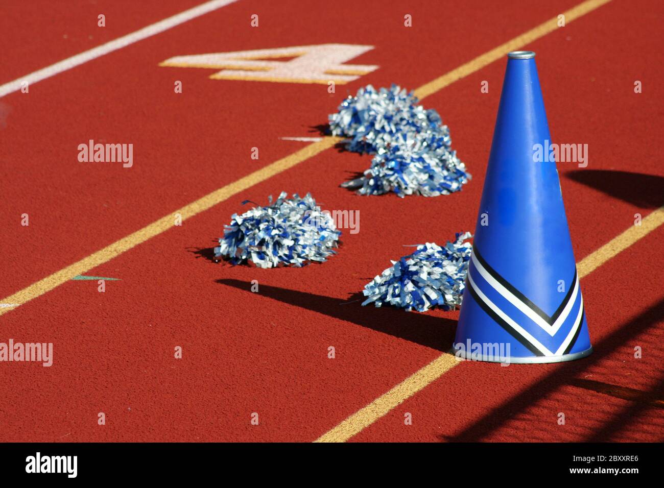 Cheerleader pom poms and megaphone at a football game Stock Photo