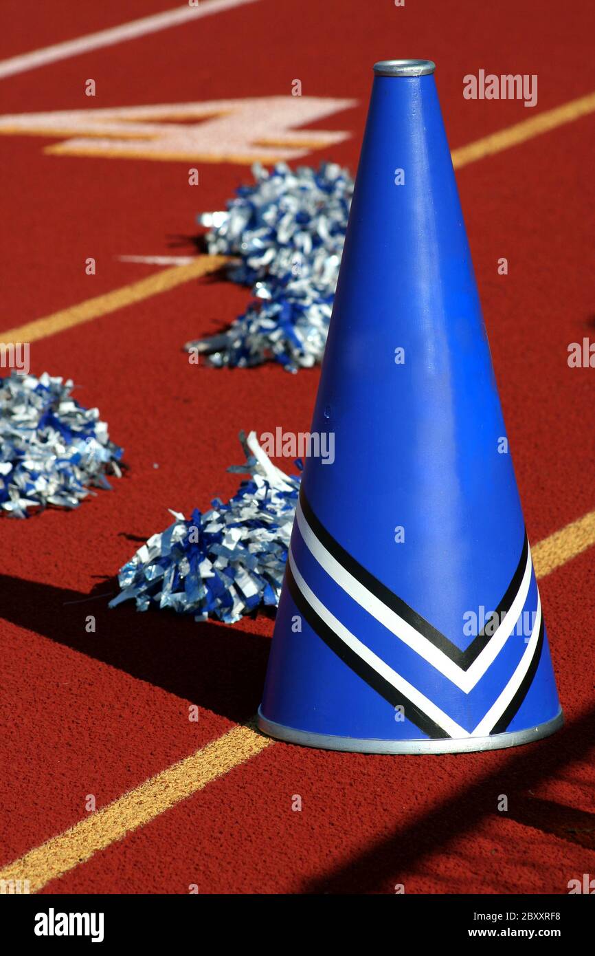 Cheerleader pom poms and megaphone at a football game Stock Photo