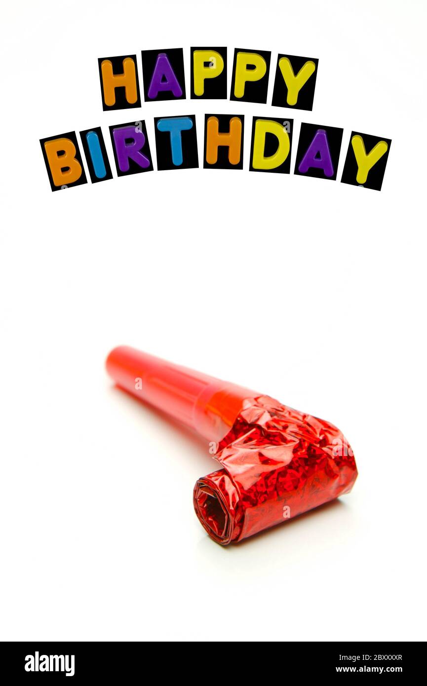 Party items with a happy birthday isolated against a white background Stock Photo