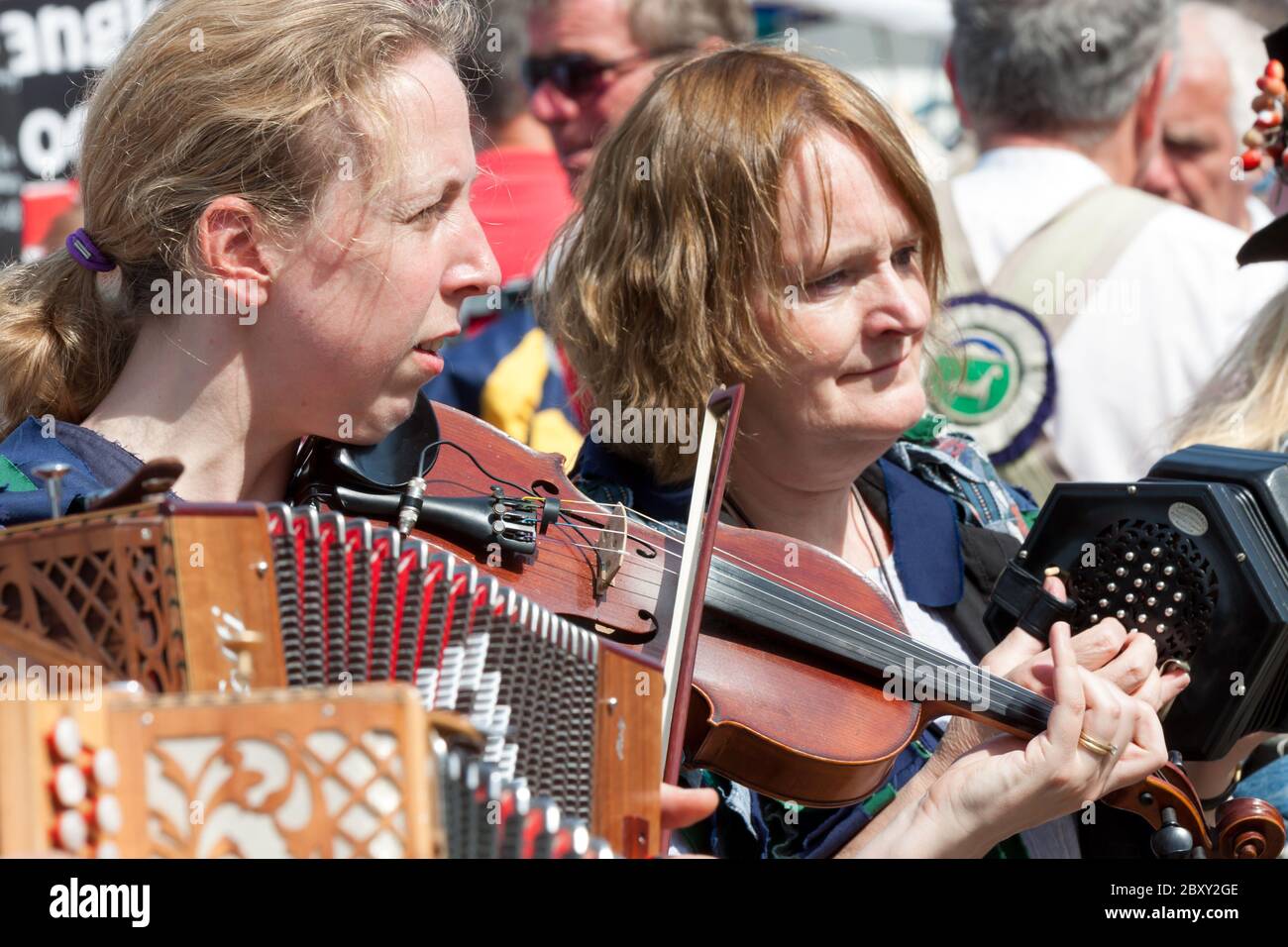 Women playing violin and accordion at a folk music festival in Weymouth, Dorset. Stock Photo