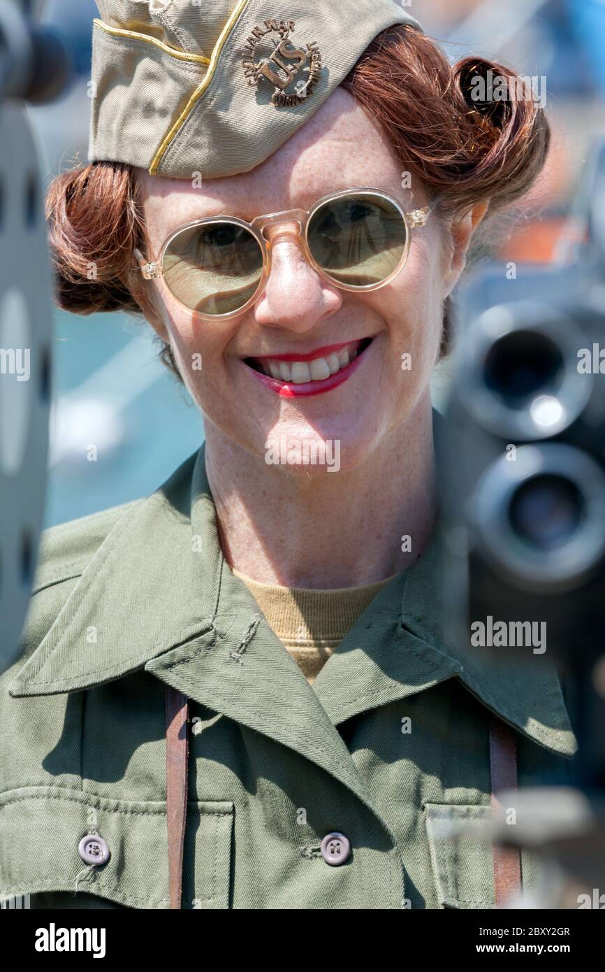 A Woman dressed in a US Civilian War Correspondent uniform during a commemoration on the 70th anniversary of D-Day in Weymouth, Dorset. Stock Photo