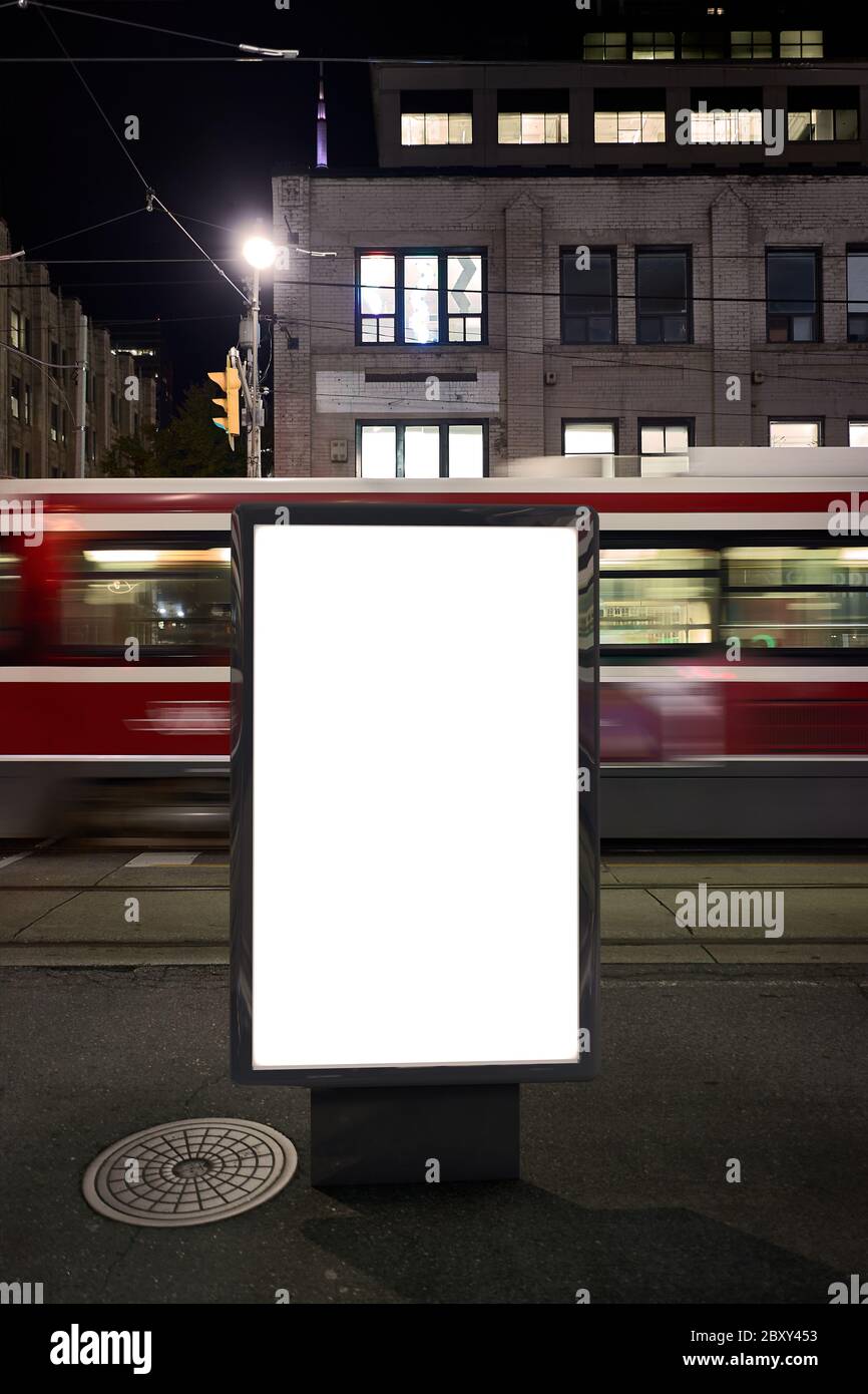 Blank advertising mockup in the street . Poster billboard on the city at night background Stock Photo