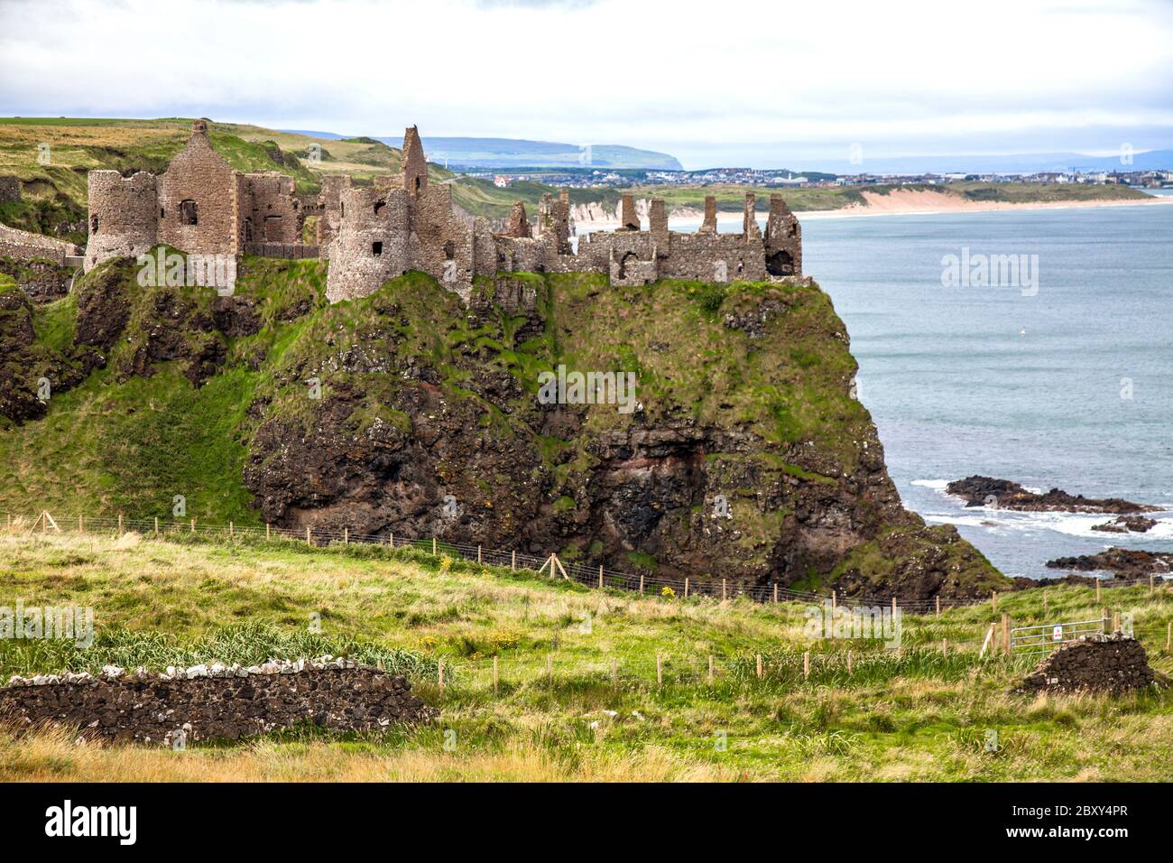 Dunluce Castle (from Irish: Dún Libhse) is a now-ruined medieval castle in County Antrim, Northern Ireland, the seat of Clan McDonnell. I Stock Photo
