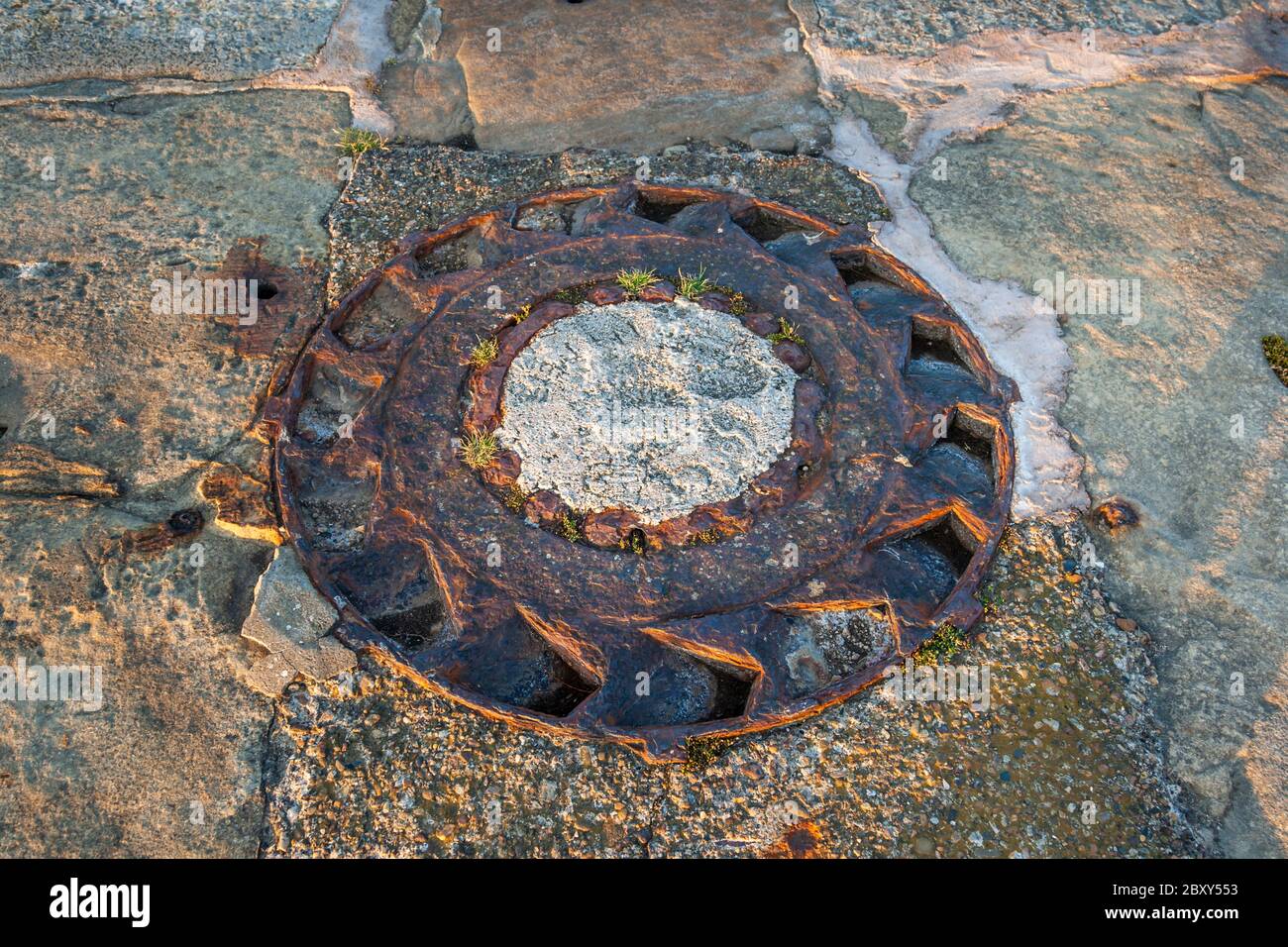 Former barb ring on the quay wall in Whitby harbor, Scarborough, England Stock Photo