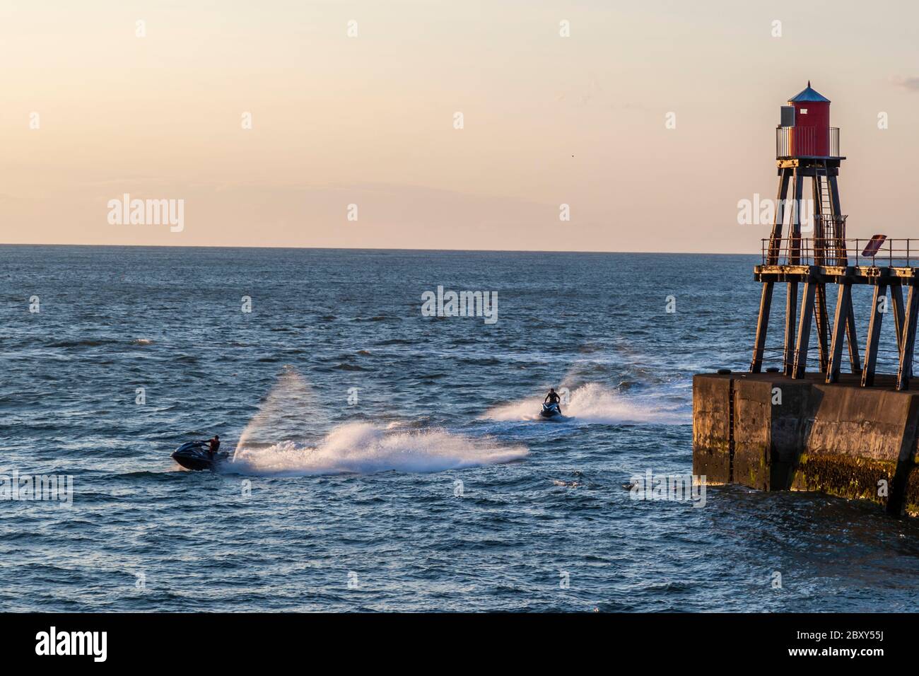 The port of Whitby with lighthous and speed boat, Scarborough, England Stock Photo