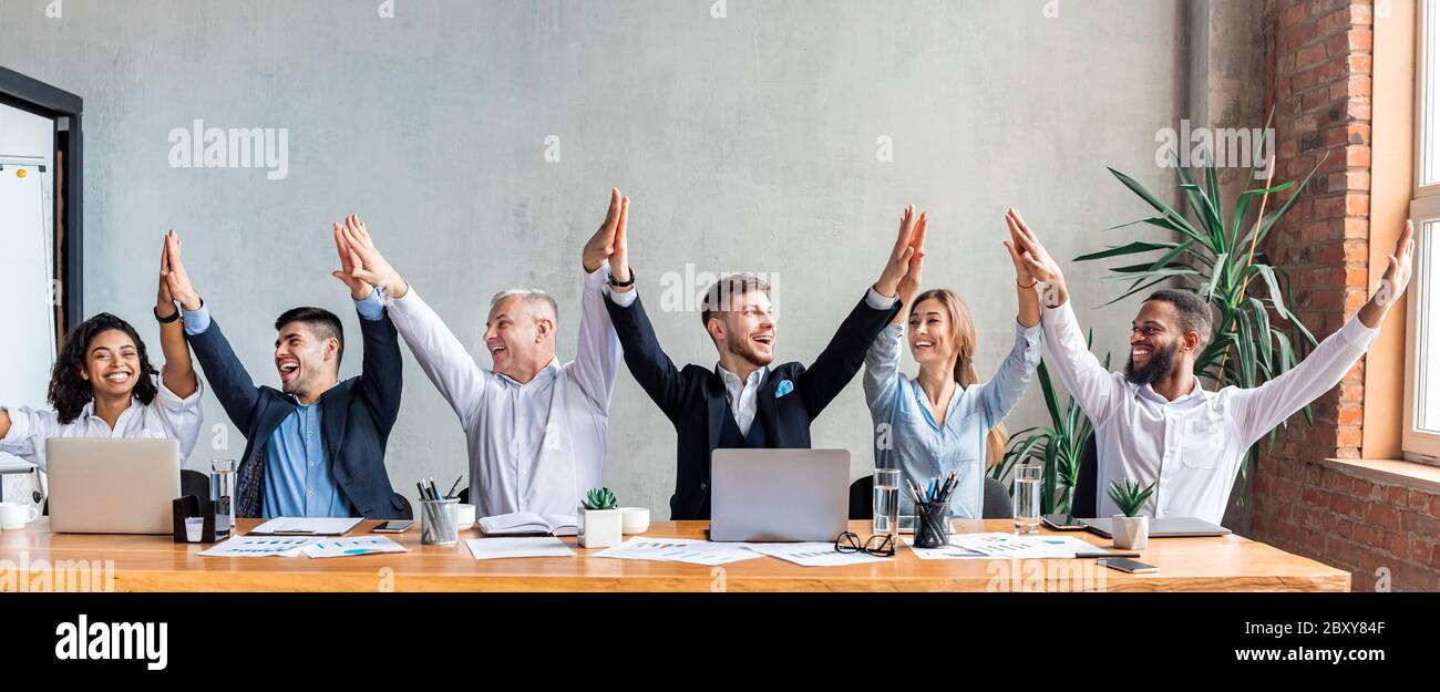 Business Colleagues Giving High-Five Celebrating Success Sitting In ...