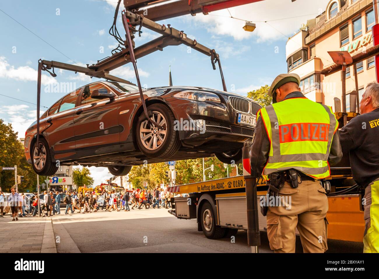 light blue car getting towed