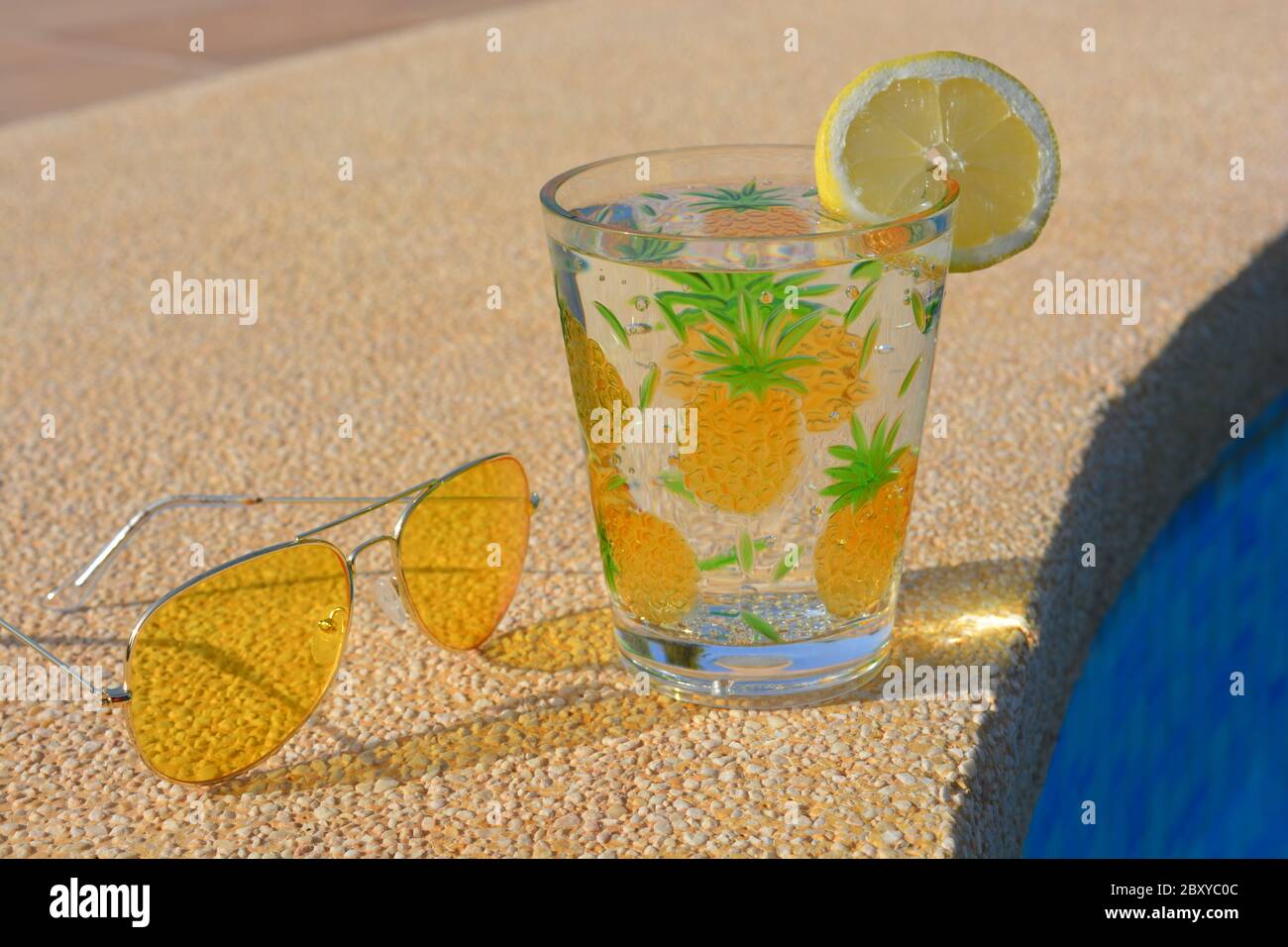 Summer vibes, metal framed yellow sunglasses and a drink in a plastic