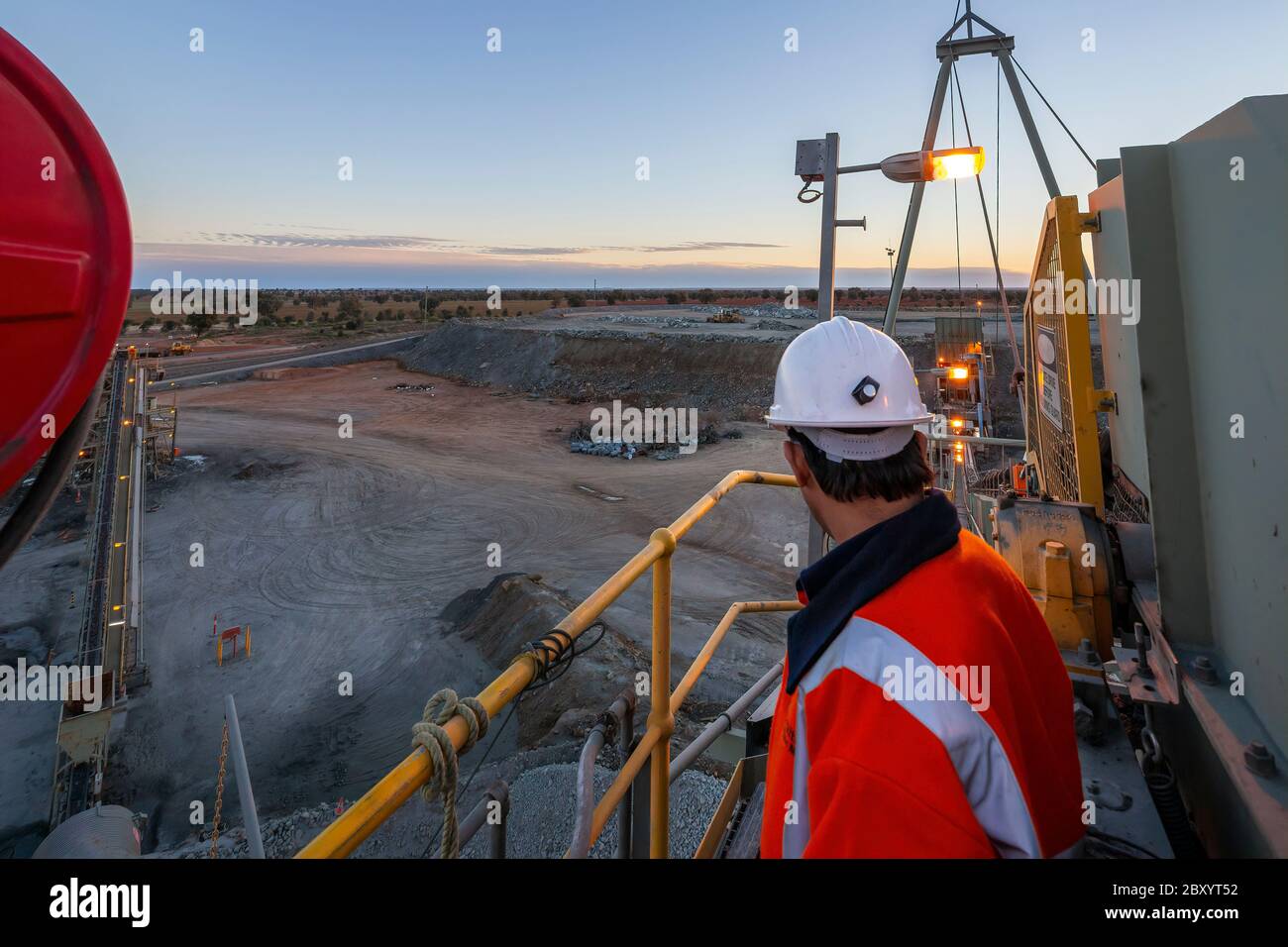 Nyngan Australia June 20th 2012 : Miner on top of a rock crushing platform surveys the minehead in NSW Australia Stock Photo