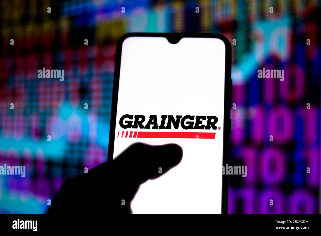 In this photo illustration the Grainger logo seen displayed on a ...