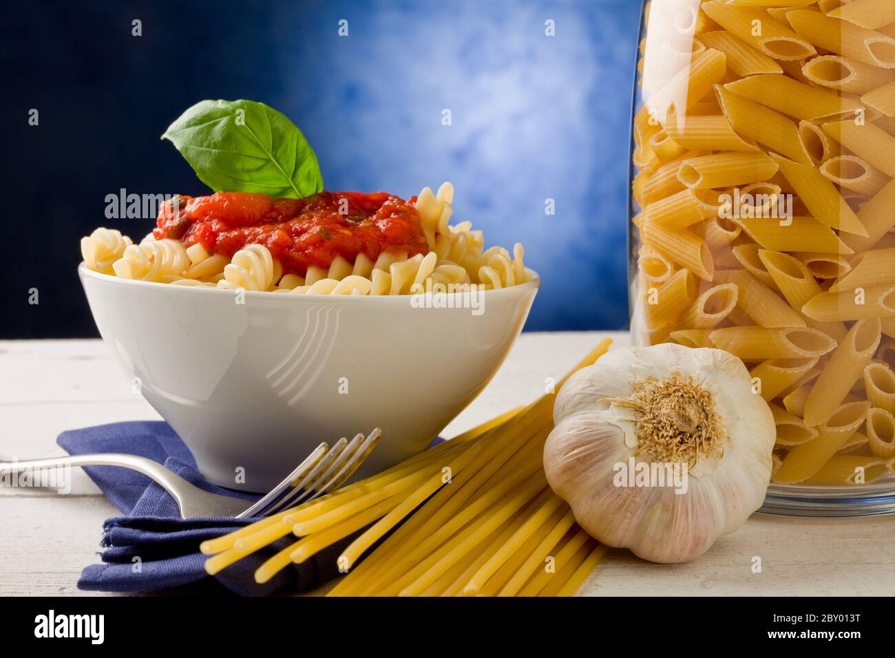 Pasta with tomato sauce on blue background Stock Photo