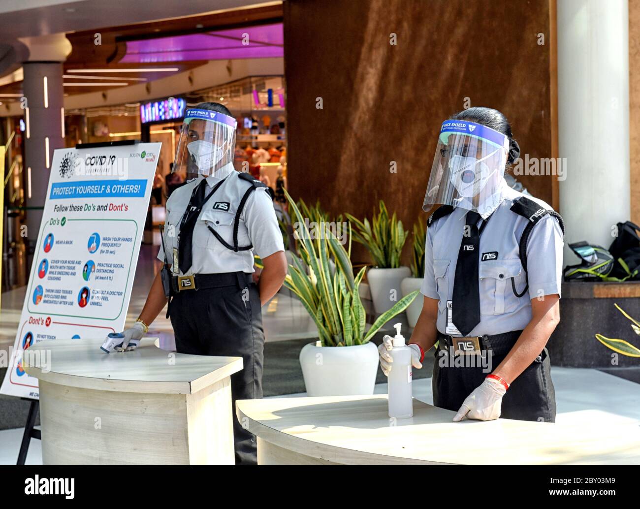 Security guards are seen standing at the main entrance of South City