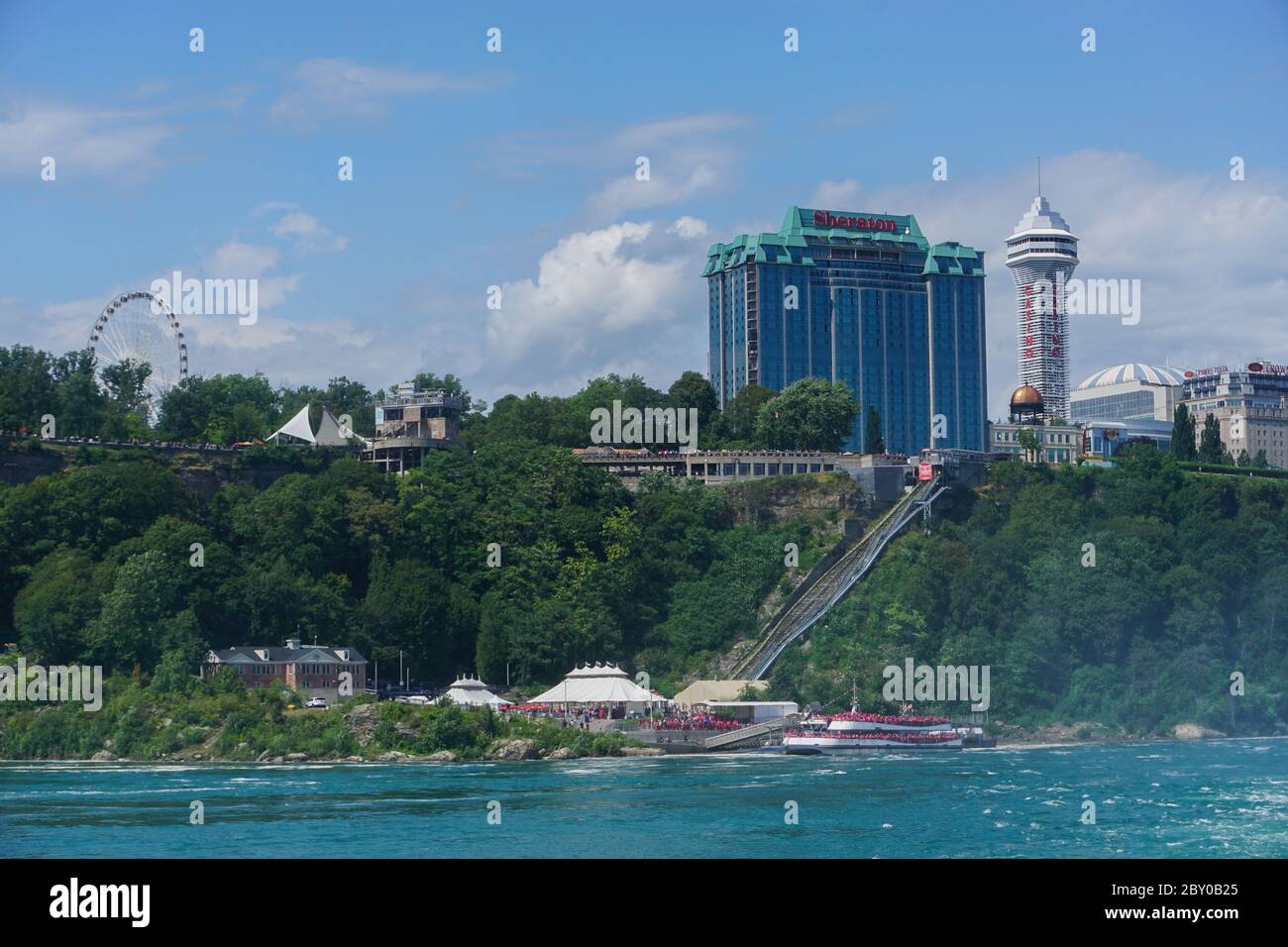 Niagara Falls, New York: Passengers fill tour boats to get a close-up view of the Falls, with the Canadian city of the same name in the background. Stock Photo