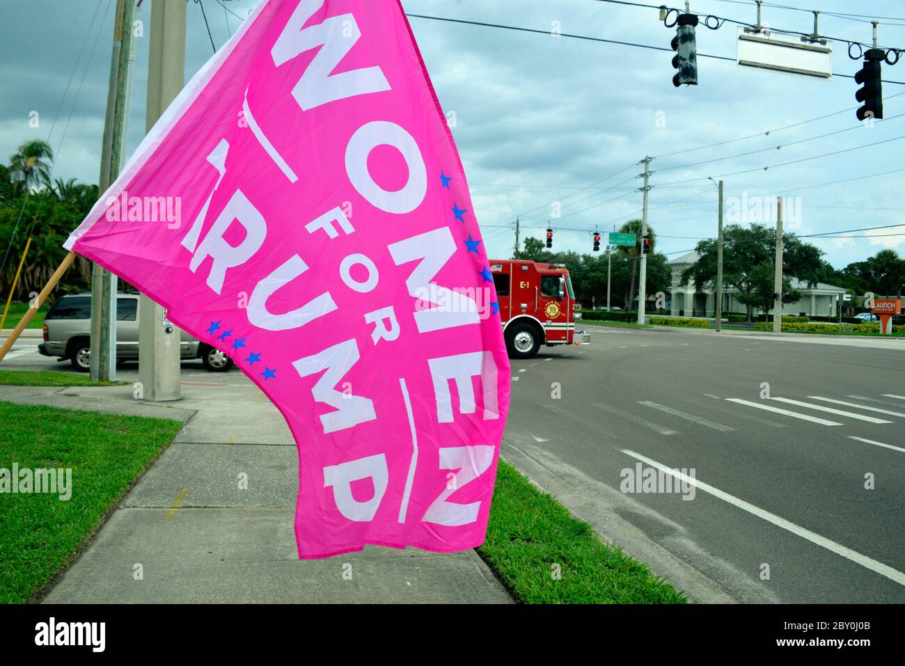 Palm Bay, Florida, USA. June 8, 2020. Small group of Trump supports gathered under cloudy sky's and light rain to wave Trump for President flags at Port Malabar Blvd. and Babcock Street. The group was greeted with honking horns high fives from passing cars and the occasional obscenity yelled out by others. Photo Credit: Julian Leek/Alamy Live News Stock Photo