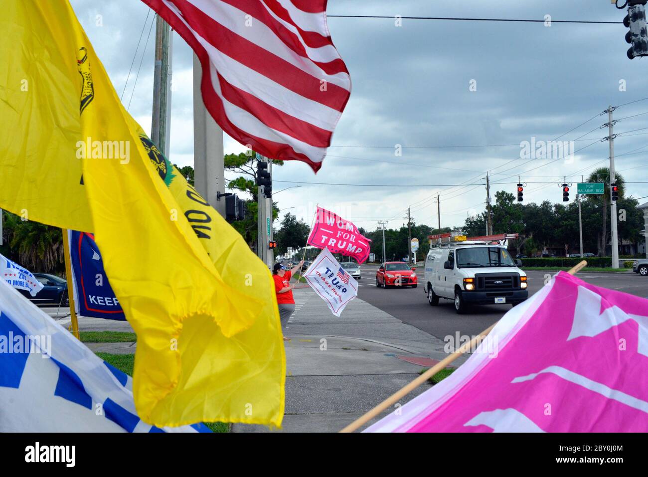 Palm Bay, Florida, USA. June 8, 2020. Small group of Trump supports gathered under cloudy sky's and light rain to wave Trump for President flags at Port Malabar Blvd. and Babcock Street. The group was greeted with honking horns high fives from passing cars and the occasional obscenity yelled out by others. Photo Credit: Julian Leek/Alamy Live News Stock Photo