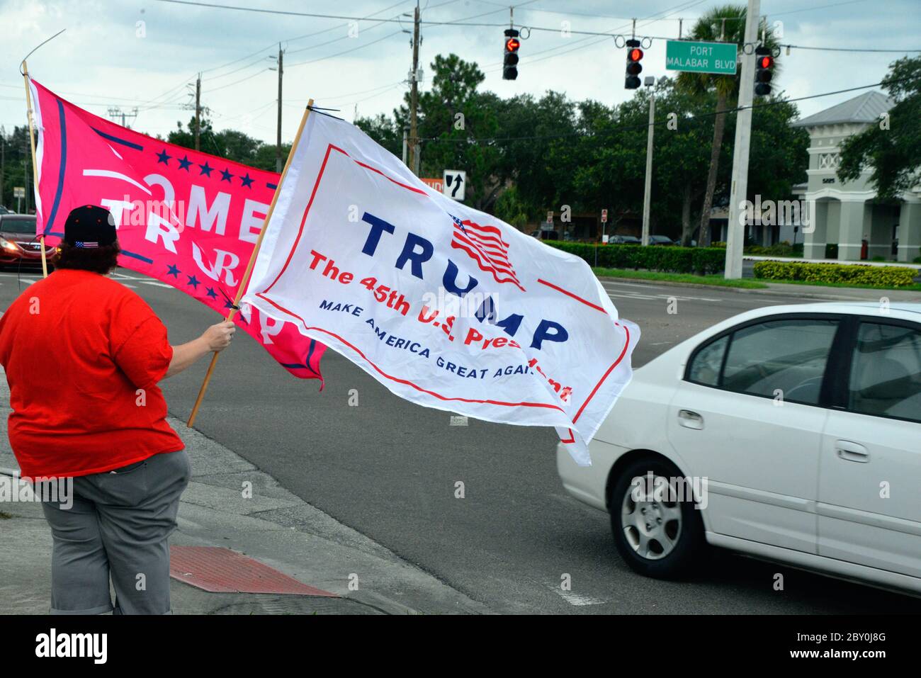 Palm Bay, Florida, USA. June 8, 2020. Small group of Trump supports gathered under cloudy sky's and light rain to wave Trump for President flags at Port Malabar Blvd. and Babcock Street. The group was greeted with honking horns high fives from passing cars and the occasional obscenity yelled out by others. Photo Credit: Julian Leek/Alamy Live News Stock Photo