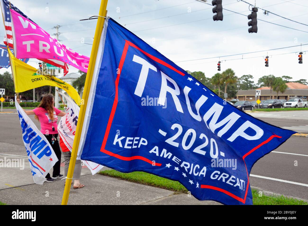 Palm Bay, Florida, USA. June 8, 2020. Small group of Trump supports gathered under cloudy sky's and light rain to wave Trump for President flags at Port Malabar Blvd. and Babcock Street. The group was greeted with honking horns high fives from passing cars and the occasional obscenity yelled out by others. Photo Credit: Julian Leek/Alamy Live News Stock Photo