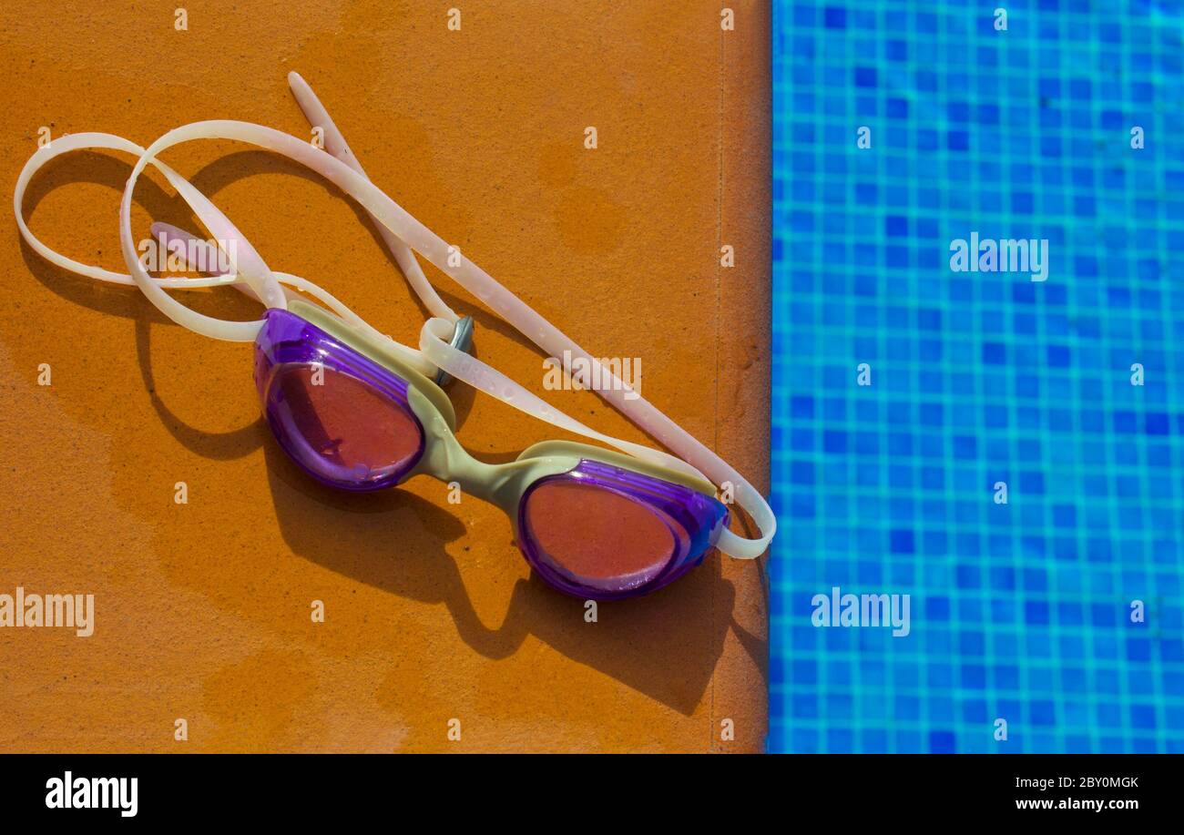 swiming glasses by pool Stock Photo