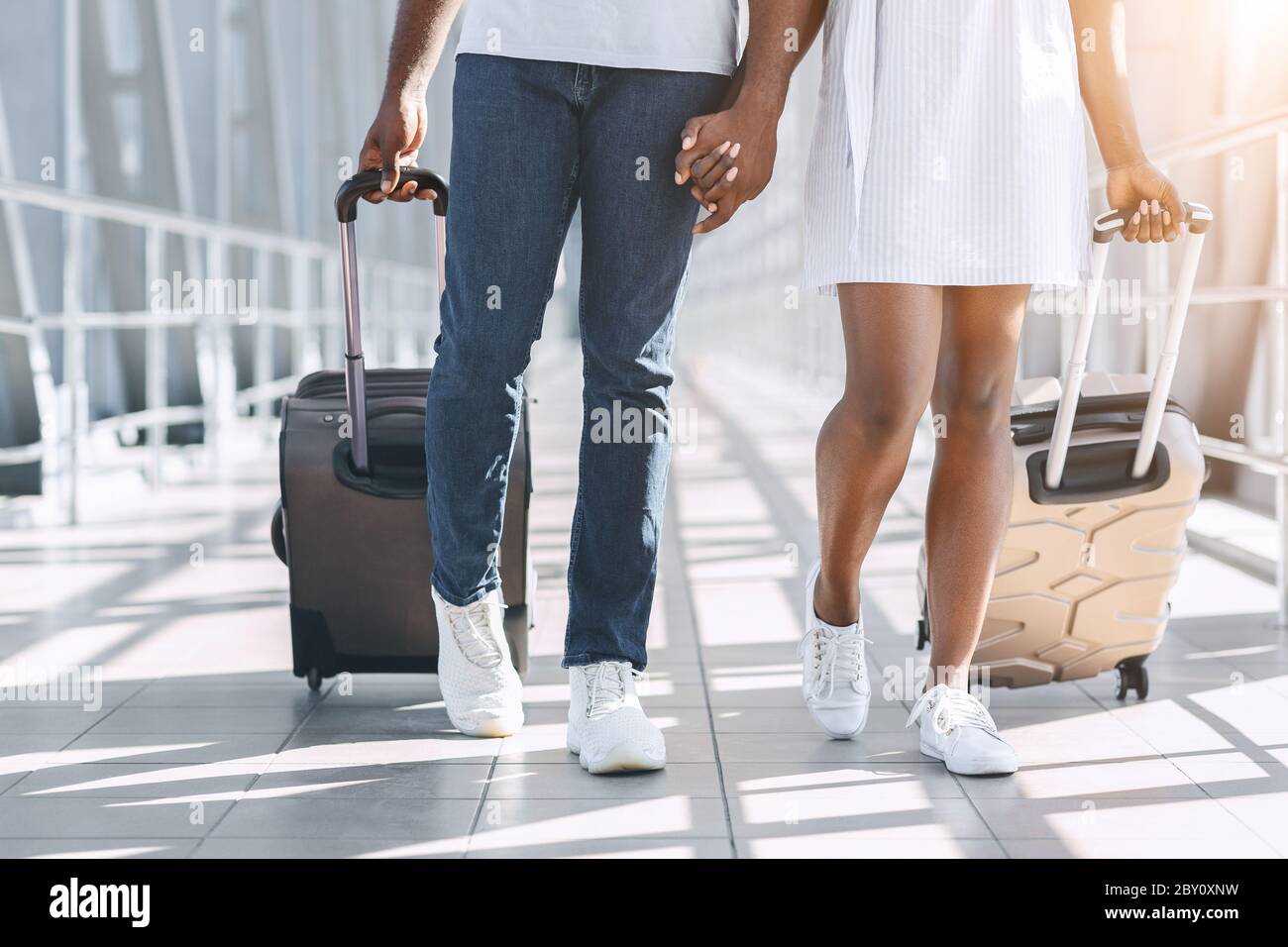 Going To Gate. African Couple Walking With Suitcases In Airport ...