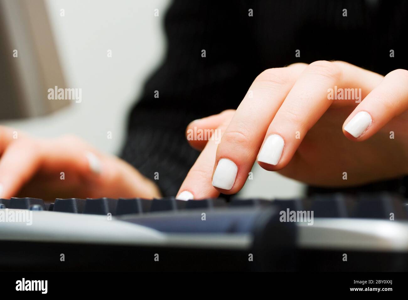 Female hands typing on computer keyboard Stock Photo