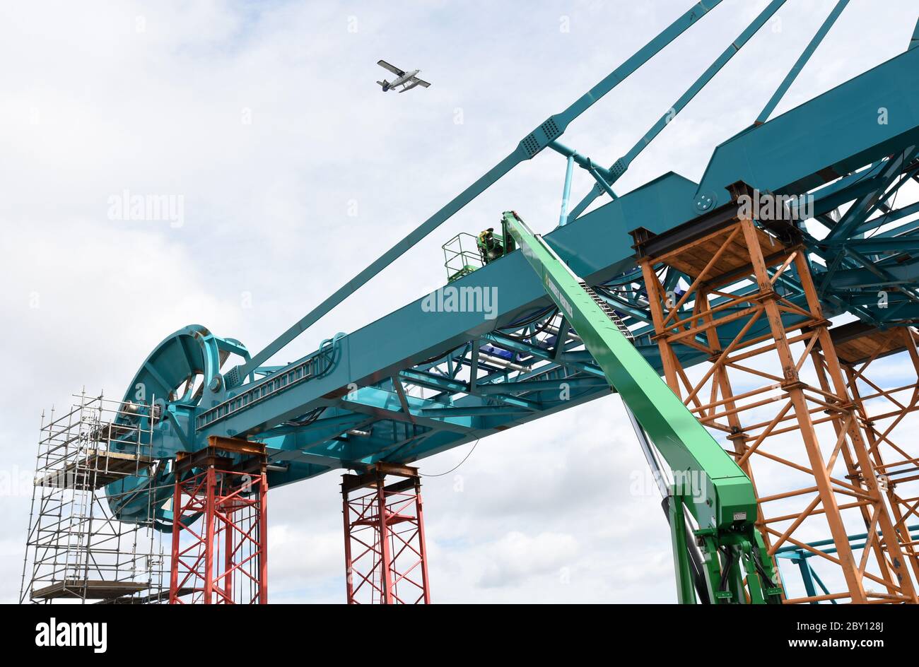 A large stacker-reclaimer takes shape at the Ralmax Group's United Engineering site on the upper harbour in Victoria, British Columbia, Canada on Vanc Stock Photo