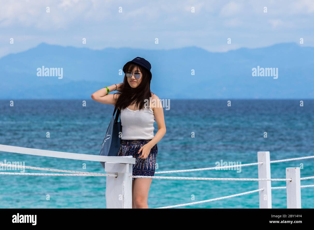 Mantanani Island, Sabah,Malaysia-CIRCA SEPTEMBER, 2017:Candid shot of a Young Asia Pretty Lady with casual white singlet , Sun glass , and cap with th Stock Photo