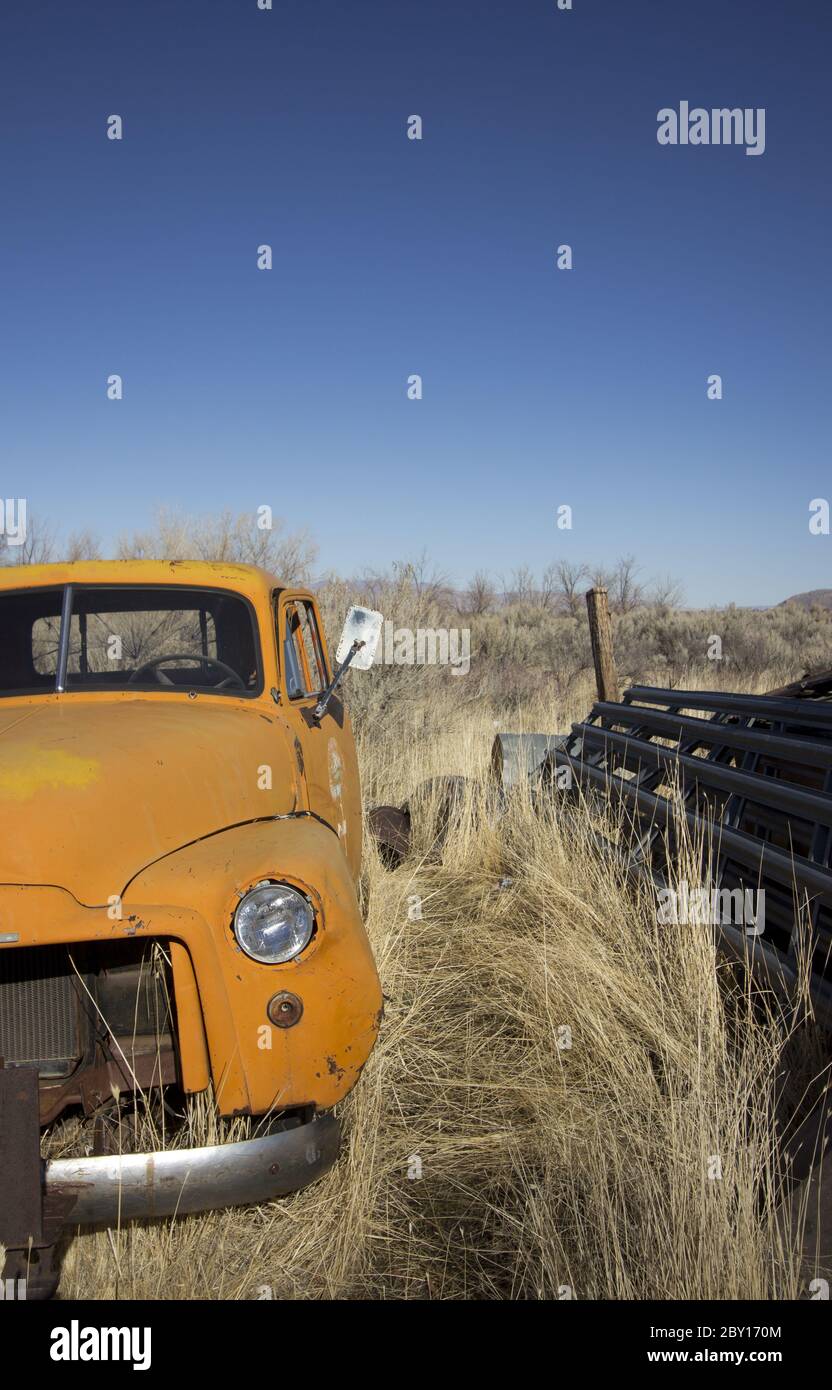 Old abandoned orange truck Stock Photo
