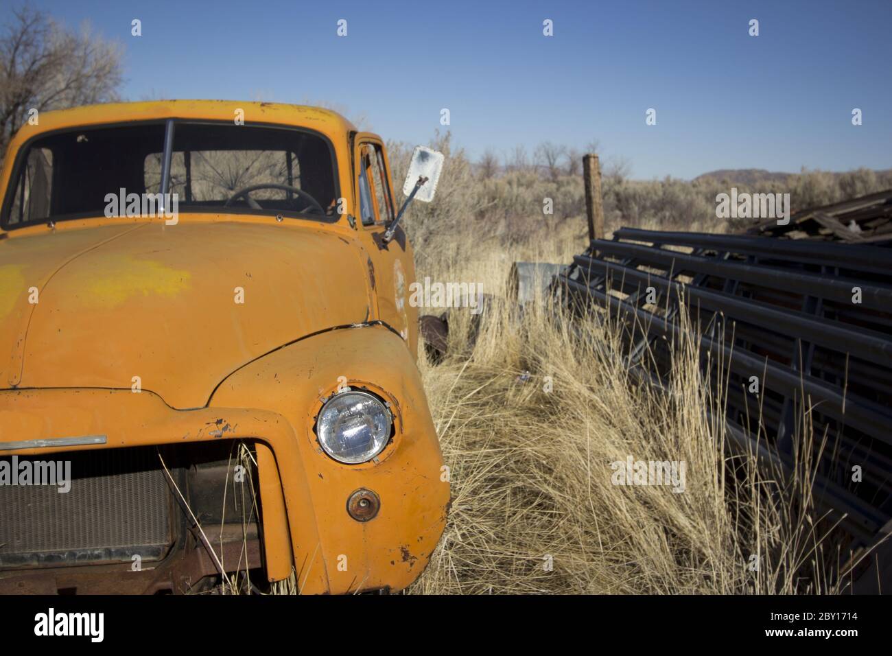 Old abandoned orange truck Stock Photo