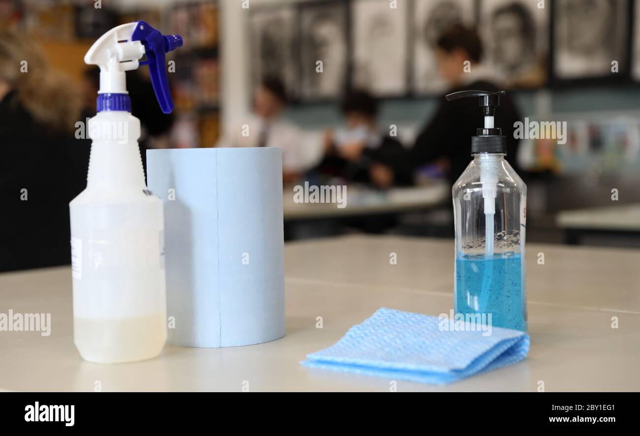an arrangement of pump hand santizer sanitiser and disinfectant on a table in a classroom. New school educational facility safe hygiene practices due Stock Photo