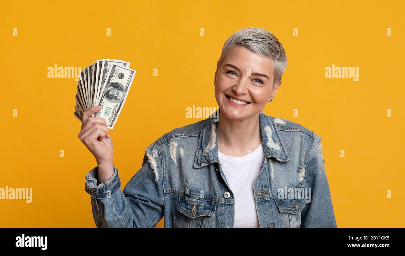 Happy mature woman money hi-res stock photography and images - Alamy