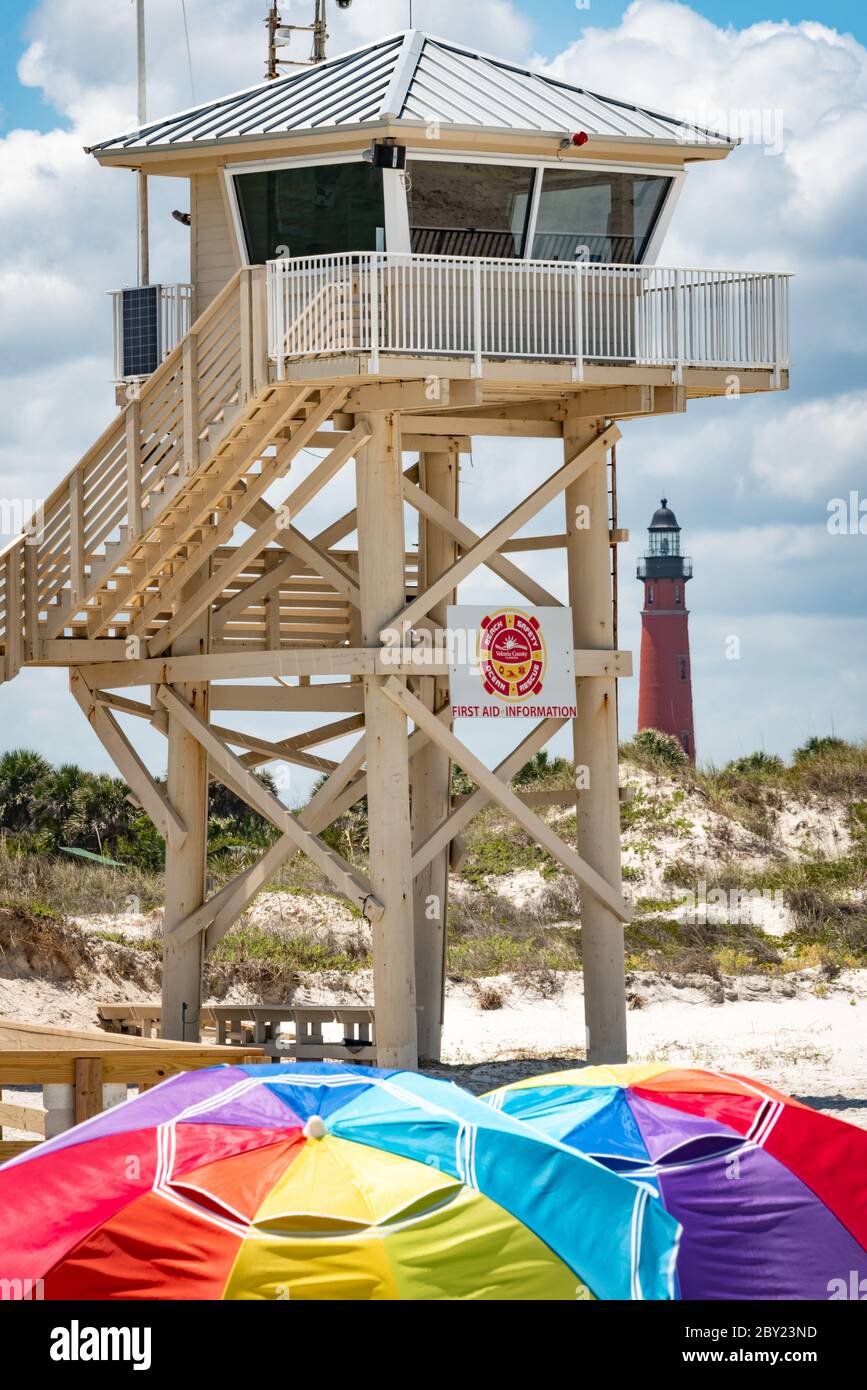 Florida beach scene at Light House Point Park, just south of Daytona Beach, with historic Ponce Inlet Lighthouse beyond the beach dunes. (USA) Stock Photo
