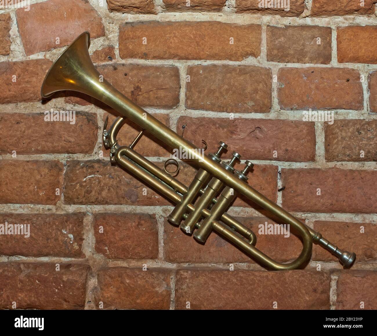 Trumpet on brick wall background Stock Photo