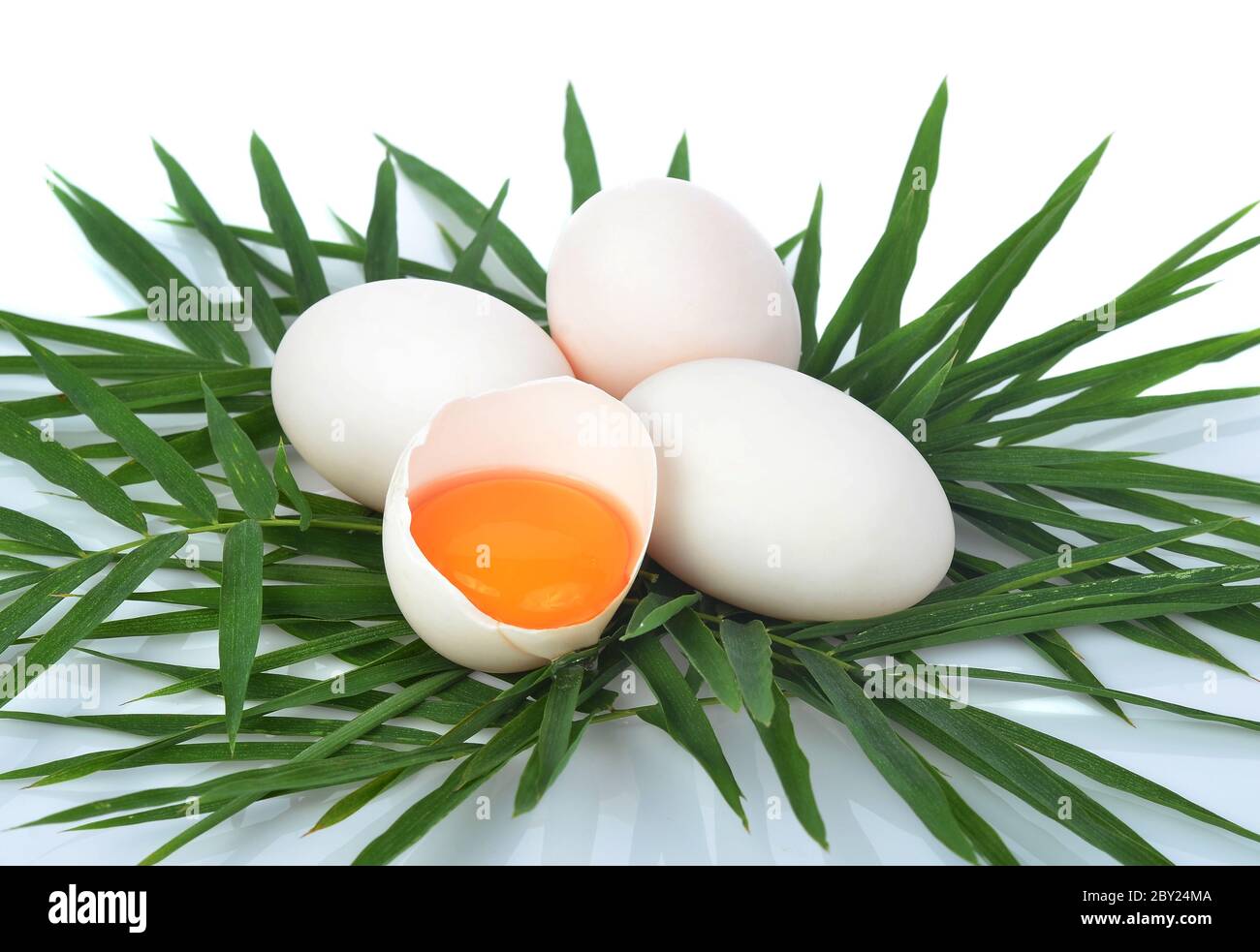 Top view of duck eggs with bamboo leaves on white backgroud Stock Photo