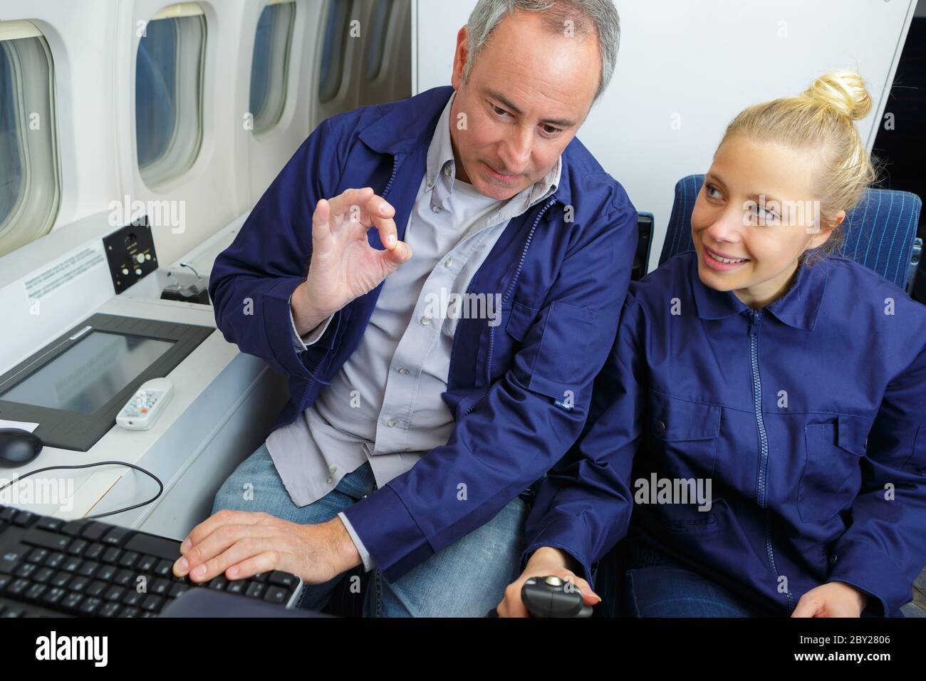 aero engineer and apprentice working in hangar Stock Photo