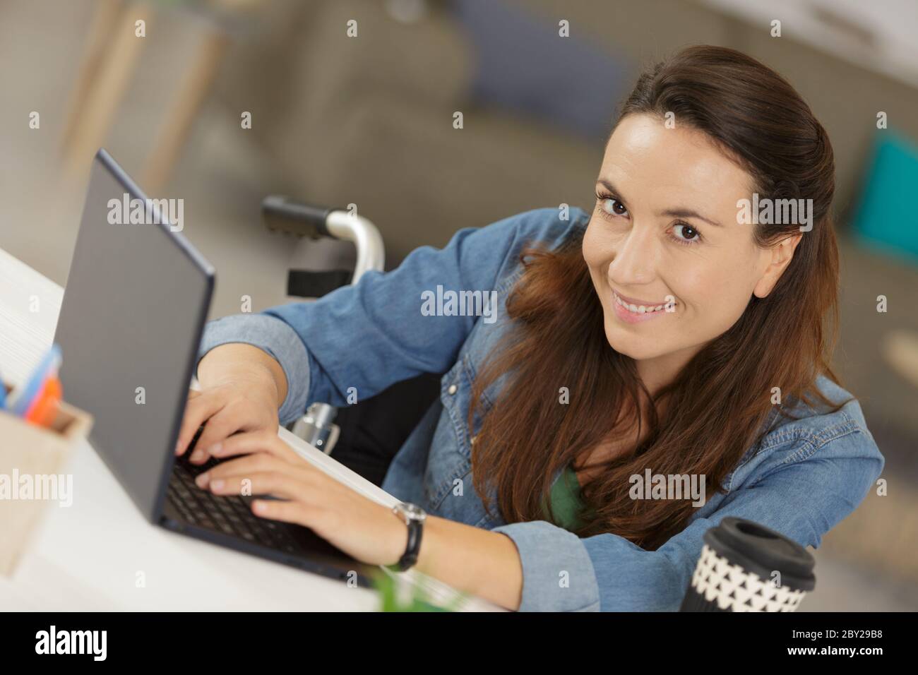 happy disabled woman in wheelchair with laptop Stock Photo - Alamy