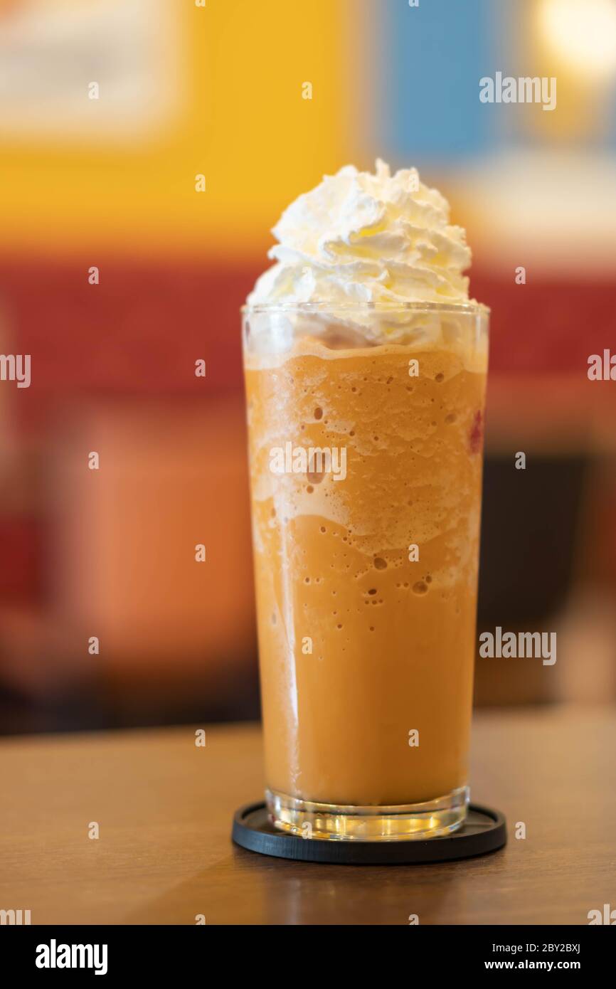 Coffee caramel frappe with whipped cream on wood table Stock Photo Alamy