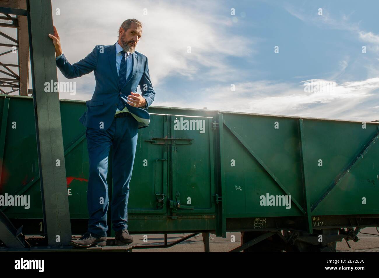 best ager posing on a steel construction Stock Photo Alamy